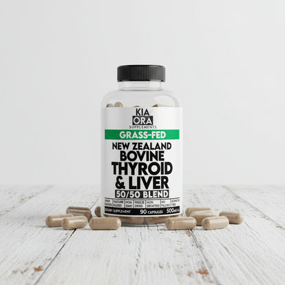 Supplement bottle labeled 'New Zealand Bovine Thyroid & Liver 50/50 Blend' by Kia Ora Supplements on a wooden surface.